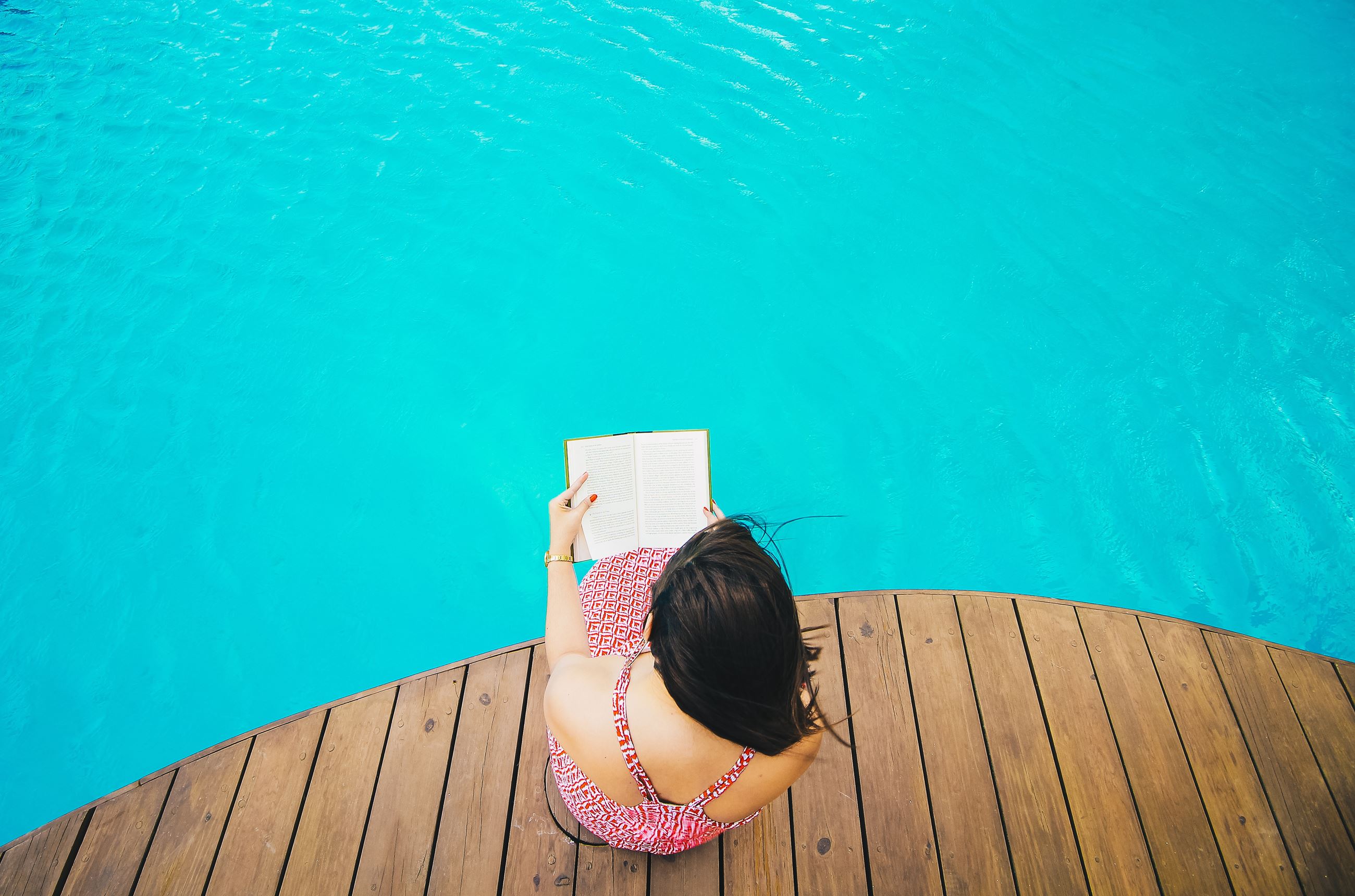 Woman reading at pool